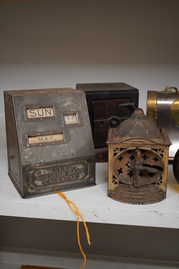 Six various metalware money boxes to include a ‘cannonball’ money box, a ‘safe’ money box, a George V ‘Royal Bank’ money box etc. 19th century and later. Condition - fair